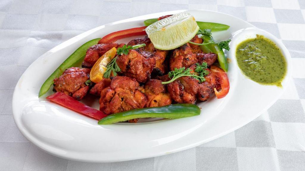 Chicken Tikka KABAB (Boneless) · Tender morsels pieces of chicken breast marinated in a yogurt and home ground spices and baked in the traditional tandoori oven.