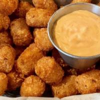 Nico’s Tater Tots · Seasoned tater tots served with Nico’s special Sriracha aioli.