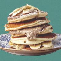 Peanut Butter Banana Pannies · 2 banana pancakes served with maple syrup, banana slices, peanut butter, butter, and dusted ...