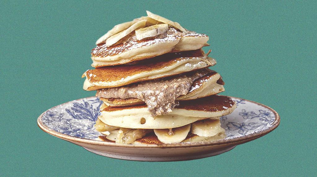 Peanut Butter Banana Pannies · 2 banana pancakes served with maple syrup, banana slices, peanut butter, butter, and dusted with powdered sugar.