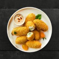 Popping Peno · Fresh jalapenos coated in cream cheese and fried until golden brown.