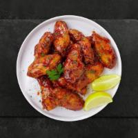 Honey Bunny Wings · Fresh chicken wings breaded, fried until golden brown, and tossed in honey. Served with a si...