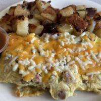 Super Meat Lover Omelette      · Bacon, Ham, Sausage & Ground beef, onions topped w/ Jack & Cheddar Cheese.