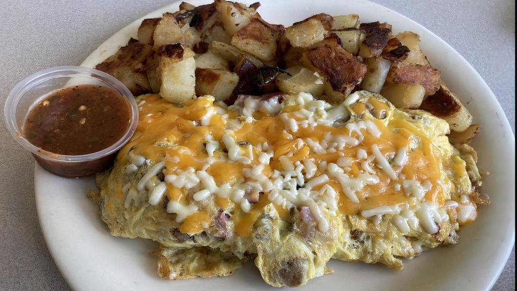 Super Meat Lover Omelette      · Bacon, Ham, Sausage & Ground beef, onions topped w/ Jack & Cheddar Cheese.