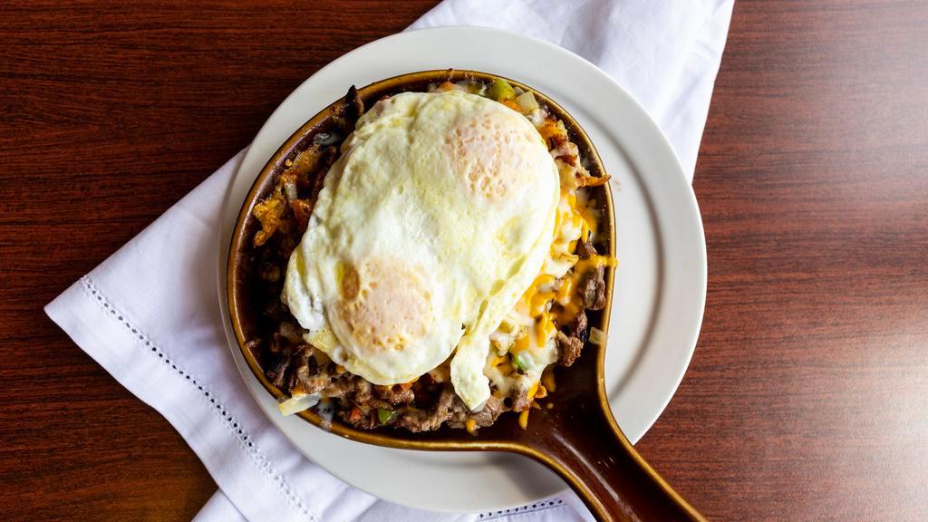 Country Fried Steak Skillet · Country fried steak topped w/ Country Potatoes, Country Gravy and Two Eggs