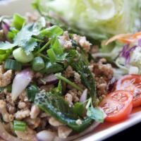 A02. Larb Salad · your choice of ground meat cooked with red and green onions, mint leaves, ground roasted ric...
