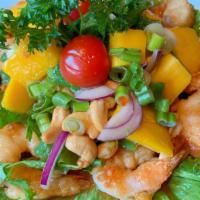 A05. Mango Shrimp Salad · Fried shrimp, mango, cashew nut, onions in spicy lime dressing, served with sliced cabbage.