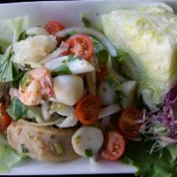 A01. Spicy Seafood Salad · Shrimps, calamari, fish balls, scallops, white fungus and sliced fish cakes with tomatoes, o...