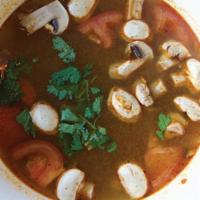 D07. Tom Yum Gai · Thai style hot and sour soup with sliced chicken, mushroom, tomato, galanga lemongrass, and ...