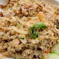 E02. Roasted Duck Fried Rice · Fried rice with boneless roasted duck, egg, white onion, green onion, and tomato, topped wit...