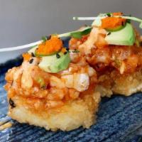 Spicy Salmon on Crispy Rice · Two pieces. Spicy salmon topped with avocado, green onion, masago, serrano, spicy aioli, and...