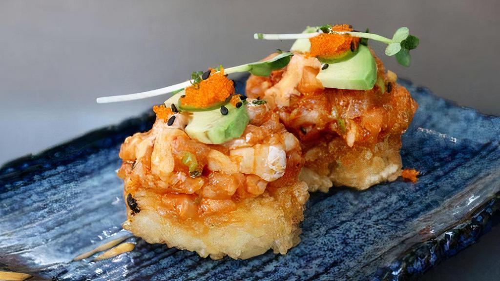 Spicy Salmon on Crispy Rice · Two pieces. Spicy salmon topped with avocado, green onion, masago, serrano, spicy aioli, and on crispy rice.