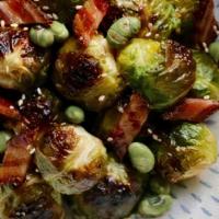 Roasted Brussel Sprouts · With miso glazed candied bacon and edamame crisps.