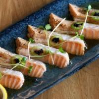 Seared Salmon Sashimi · Salmon, serrano, masago, chives, sesame seeds, ponzu, and garlic oil.