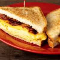 Breakfast Sandwich · Choice of bacon, sausage, ham or chorizo with cheese & egg served on toast. croissant is EXT...