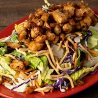 Warm Chicken Asian Caesar Salad · Asian marinated chicken, crispy romaine leaves, red & green cabbage, shredded carrots, Asian...