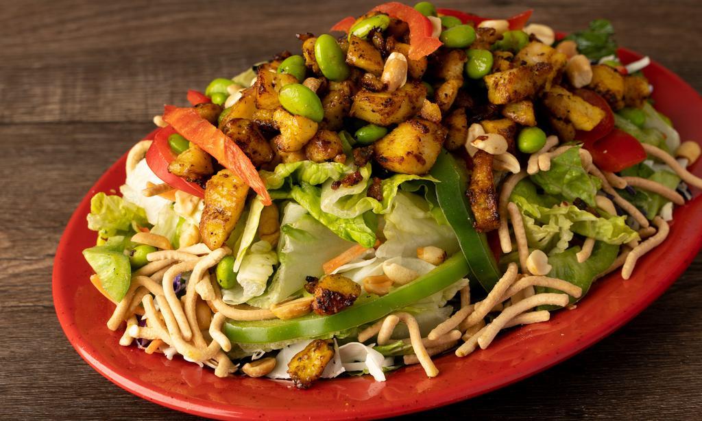 Thai Chicken Caesar · Freshly grilled chicken, romaine, red & green cabbage, shredded carrots, red pepper, toasted peanuts, crispy wonton noodles, fresh edamame & homemade spicy Thai-peanut dressing.