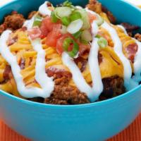 Turkey Chili Bowl · Turkey chili, cheddar cheese, salsa, sour cream, tomatoes and scallions over brown rice.