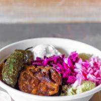 Spicy Eggplant Bowl · A fiery bowl filled with couscous, garbanzo beans, eggplant hummus, eggplant, jalapenos, dol...