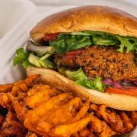 Earth Burger · Vegan. Vegan falafel patty topped with lettuce, tomato, onion, pickles and ketchup, served w...