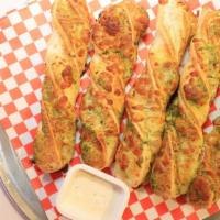 Garlic Cheese Twists · Garlic, cheese, ranch and herb seasoning twisted into the perfect dippable and cheesy breads...