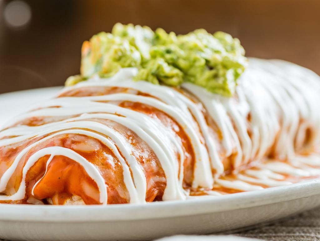Wet · Super burrito with beans, pico de gallo and salsa. Smothered with the Mexican's own enchilada sauce, topped with guacamole, cheese, and sour cream.