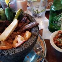 Molcajetes · At the Mexican, molcajetes are served hot with outside skirt steak, chicken breast, jumbo sh...