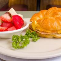 Croissant Breakfast Sandwich · Cal. 785-1198. Our award-winning items. Ham, or turkey, eggs, and cheese layered on a grille...