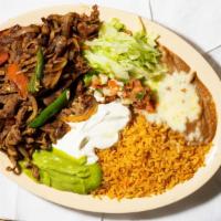 Beefsteak Ranchero · Streak strips sautéed with onions, tomatoes, and jalapenos served with rice, refried beans, ...
