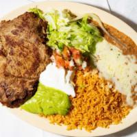 Carne Asada Plate · Two pieces of Grilled Carne Asada served with rice, refried beans topped with cheese, pico d...