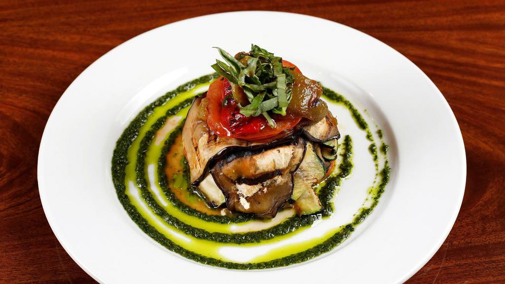 Caprino con Vegetali · Grilled layers of zucchini, eggplant, bell peppers, tomatoes, and Goat cheese in a pesto sauce.