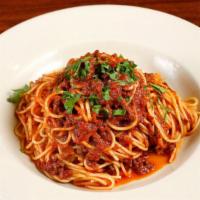 Spaghetti Bolognese · A traditional tomato based sauce cooked with local grass-fed beef over spaghetti cooked al d...