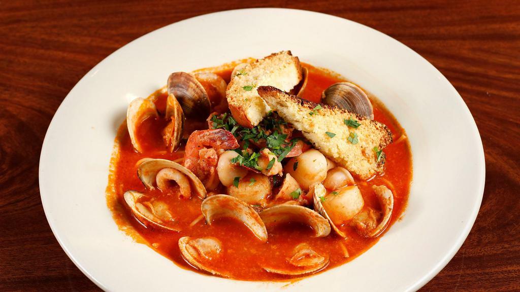 Zuppa di Pesce · Sautéed clams, small shrimp, calamari, scallops, and seasonal fish in a light tomato broth served with spaghetti and garlic crostinis.