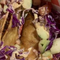 Baja Fish Taco · Breaded white fish into corn tortilla topped with cabbage and cucumber, pico de gallo and ch...