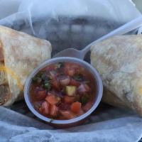 #7. Breakfast Burrito · 2 eggs, hash brown, ham, bacon, sausage, cheddar cheese,  and monterey jack cheese.  served ...