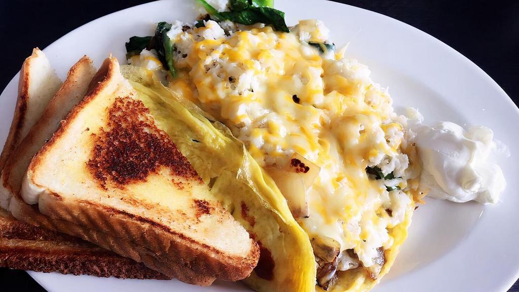 #6. Crab Breakfast (omelet) · Real crabs, 2 eggs, grilled bell pepper, onion, mushroom, spinach, zucchini, garlic, cheddar, Monterey jack cheese, and choice of toast.