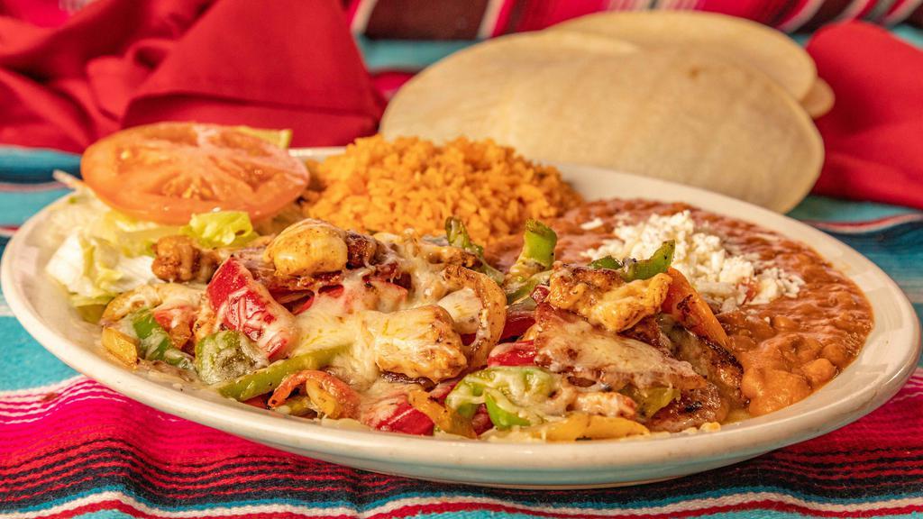 Alambres · Beef or chicken cooked with bell peppers, tomatoes, onions, bacon, and topped with cheese and salsa. Served with rice, beans, salad, and tortillas.