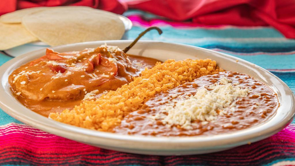 Chile Relleno · Filled with cheese and topped with non-spicy sauce. Served with rice, beans, and tortillas.