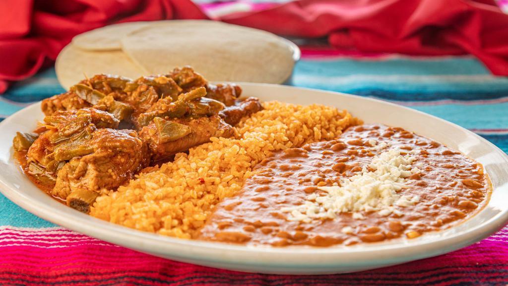 Costillas · Spicy pork short ribs. Served with rice, beans, and tortillas.