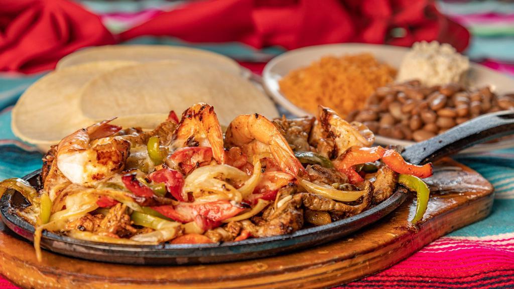 Cielo, Mar, Y Tierra · Served with rice, beans, and tortillas. Chicken, shrimp, and beef cooked with bell peppers, onions, and cheese.