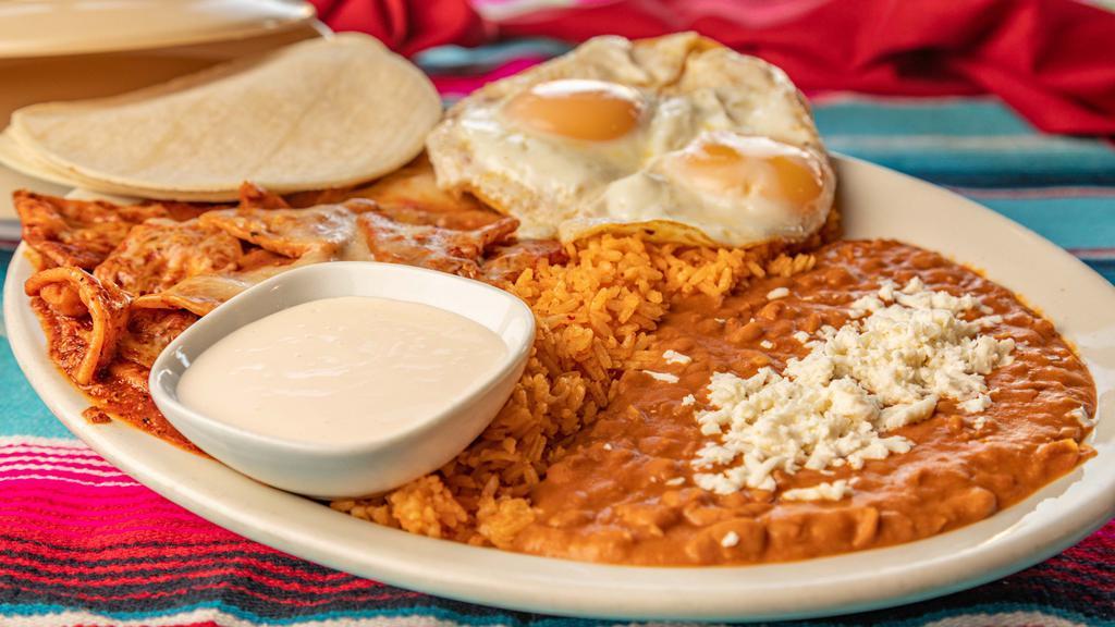 Chilaquiles · Served with rice, beans, and two eggs. Fresh chips covered in cheese and mild red or mild green salsa.
