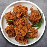 Onion Pakora · Slices of onion dipped in a light batter and fried until golden brown.