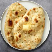Garlic Gains Naan · Freshly baked bread in a clay oven garnished with garlic and butter