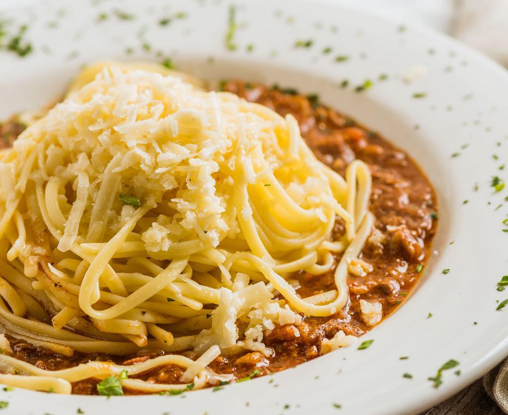 Yia Yia’s Pasta Bolognese · Our homemade tomato meat sauce made up of ground chuck, sausage, shredded pork loin and tri-tip. Topped with shredded asiago.