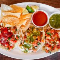 Tacos · Choice of meat, beans, onions and cilantro and salsa.