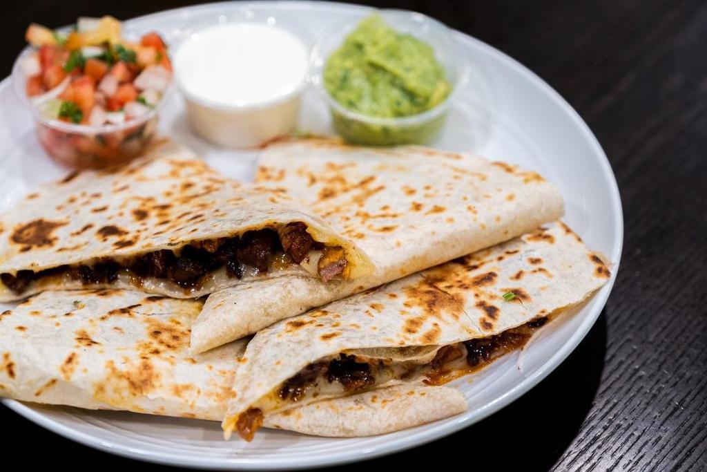Meat Quesadilla · Flour tortilla grilled with your choice of meat, guacamole, fresh salsa, and sour cream on the side. Complimentary Salsas of your choice.