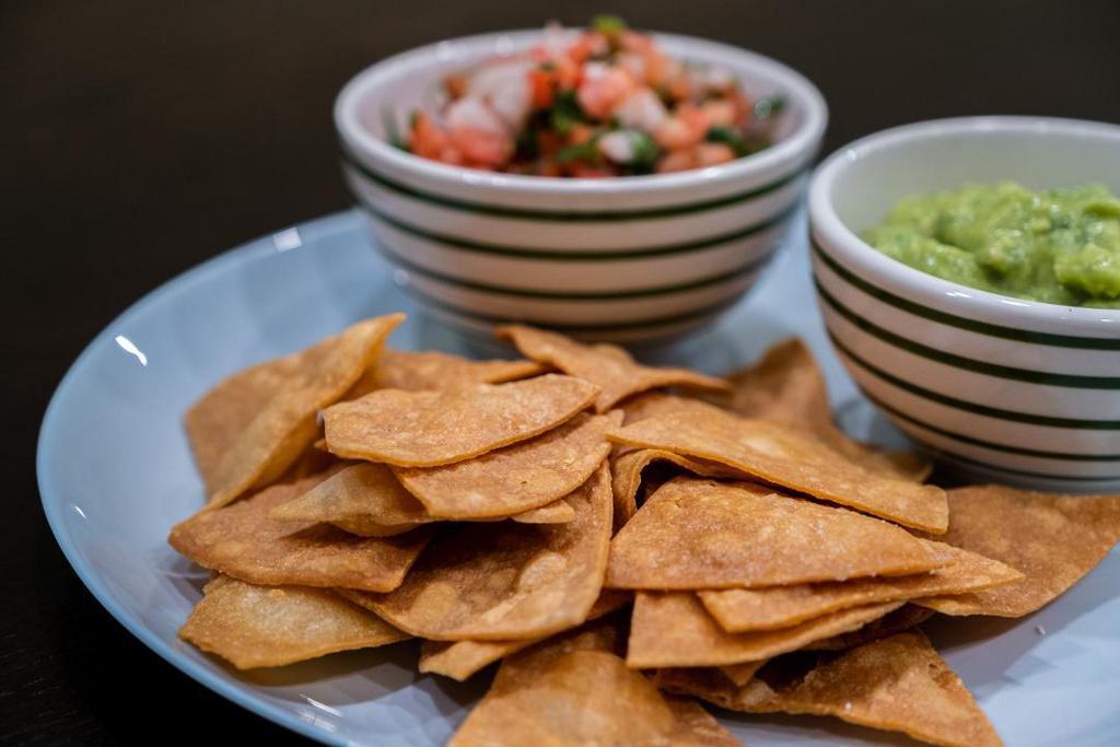 Guacamole and Chips · Fresh smashed avocados with onions, cilantro, lime juice, and house-made corn chips.