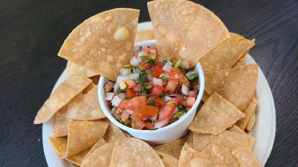 Fresh Salsa and Chips · Fresh diced tomatoes, onions, chopped cilantro, and lime juice are all mixed with house-made chips.