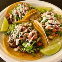 Taco Americano · Corn tortilla, Flour tortilla, or Crispy shell, your choice of protein topped with lettuce, ...