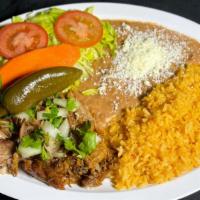 Carnitas Plate · Shredded pork with rice and beans, topped with spicy or mild salsa
